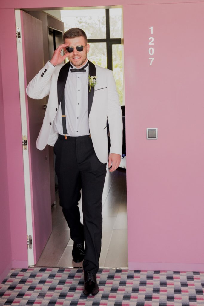 Groom white jacket black lapels destination wedding Spain