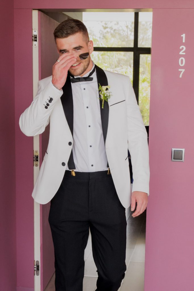 Groom white jacket black lapels destination wedding Spain