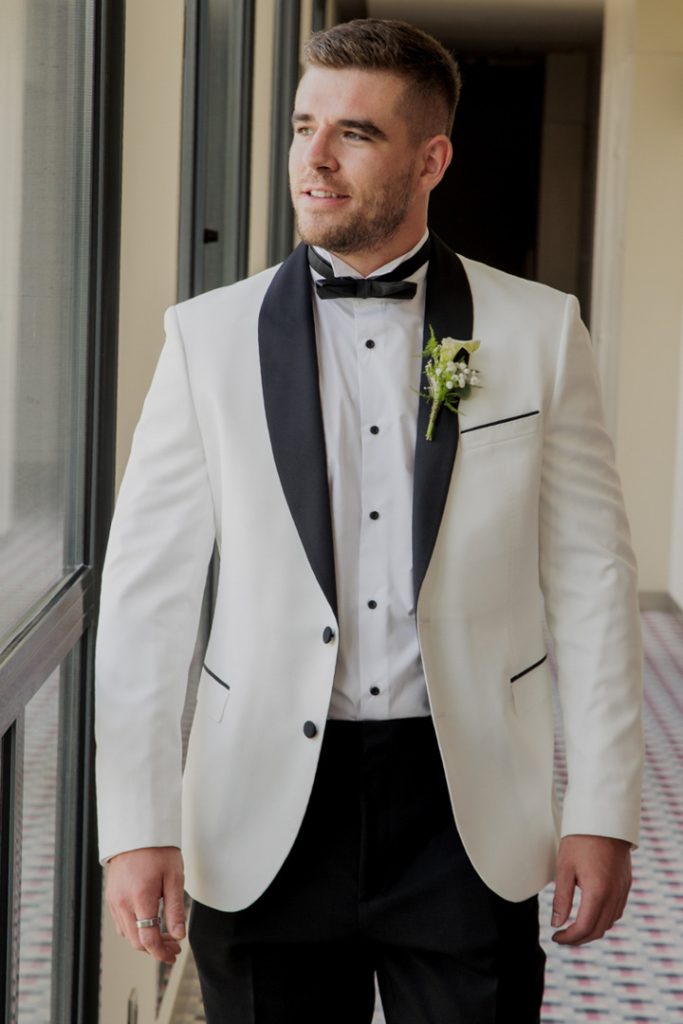Groom white jacket black lapels destination wedding Spain
