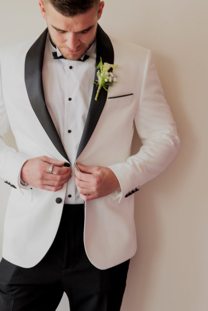 Groom white jacket black lapels destination wedding Spain