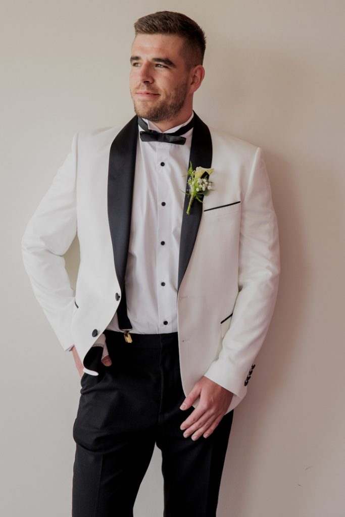 Groom white jacket black lapels destination wedding Spain