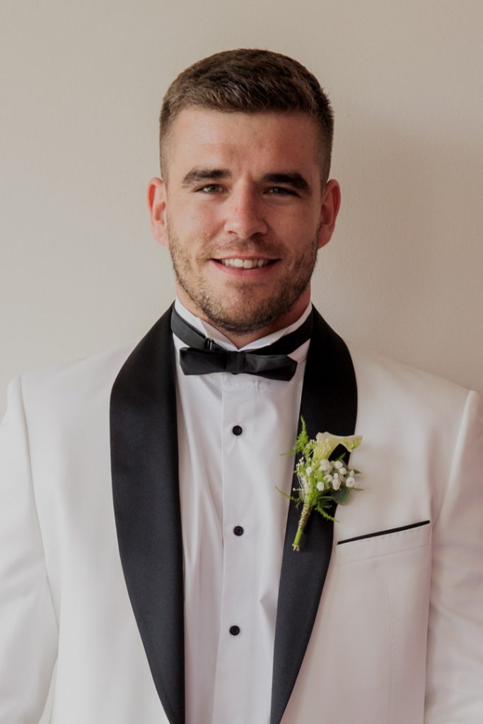 Groom white jacket black lapels destination wedding Spain